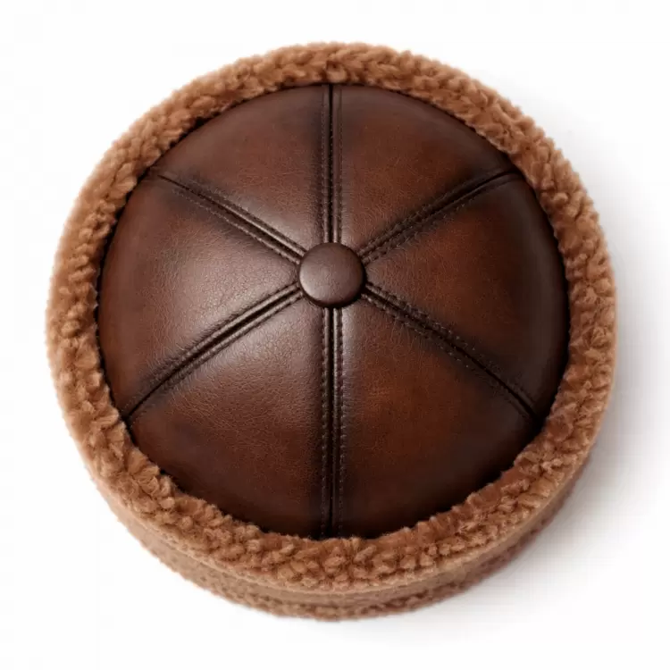 Handmade leather gifts for men: real brown lambskin börk hat viewed from above with stitched leather crown and lamb-fur trim